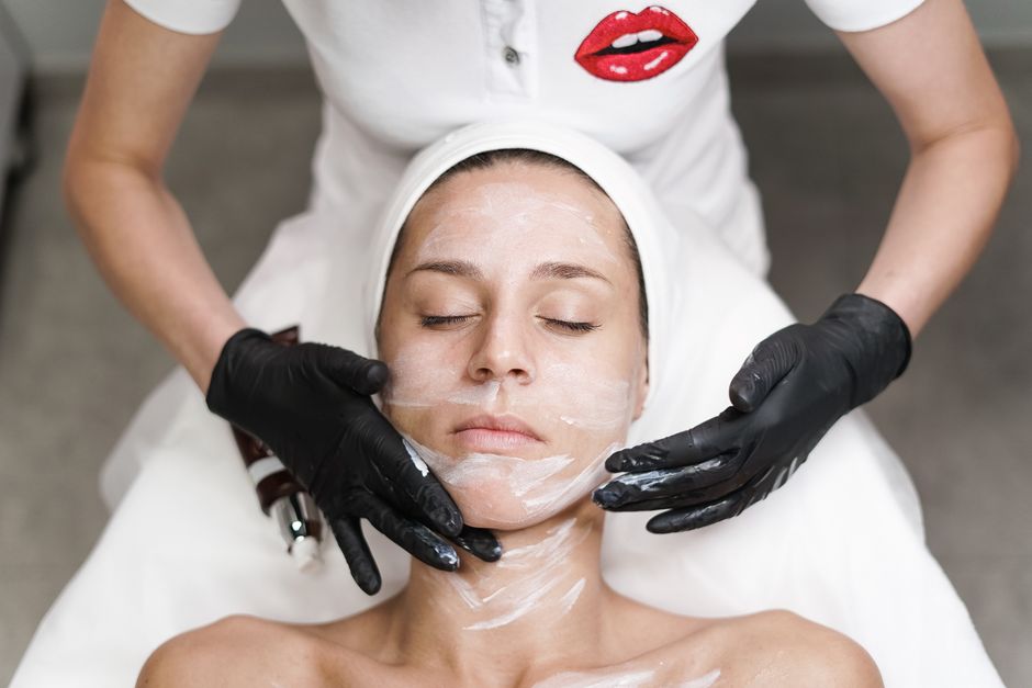 Esthetician treating a patient in a clinic